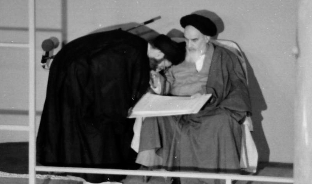 Ali Khamenei receives his validity sentence from Ruhollah Khomeini for presidency while kissing his hand